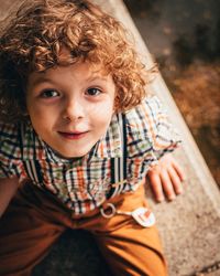 High angle portrait of cute boy sitting outdoors