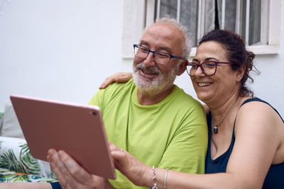 Portrait of happy man using mobile phone