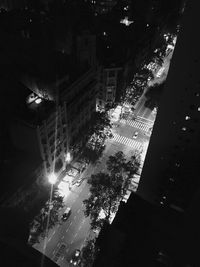 High angle view of illuminated street amidst buildings at night