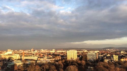 Cityscape against cloudy sky