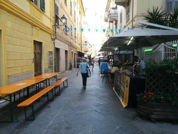 Woman walking on sidewalk in city