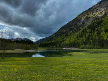 Scenic view of lake and mountains against sky