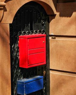 Close-up of red mailbox on door