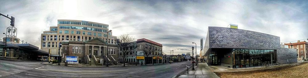 Buildings in city against cloudy sky