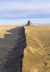 Aerial with leading line of lava towards shiprock in new mexico