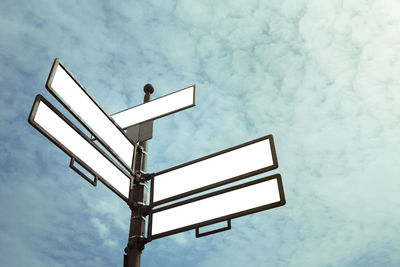 Low angle view of sign against sky