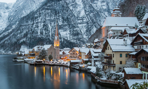 Buildings by lake during winter in hallstatt