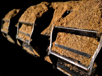 Close-up of rusty metal against black background