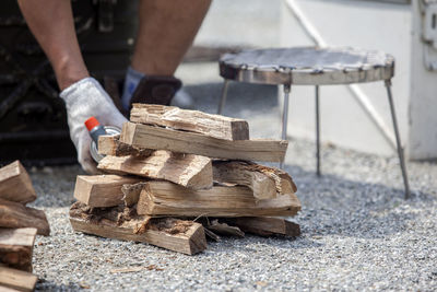 Cropped image of man burning firewood at campsite