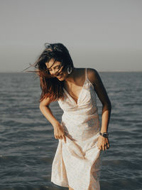 Young woman standing at beach