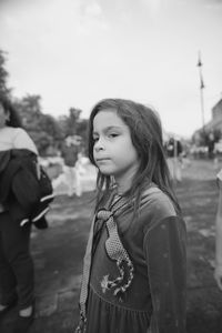Low angle view of young woman standing outdoors