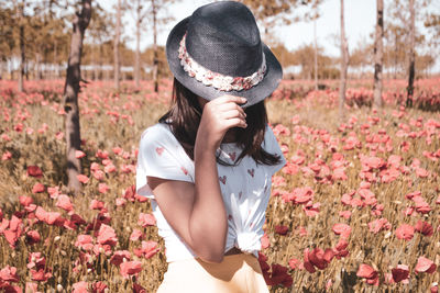 Young woman standing amidst plants