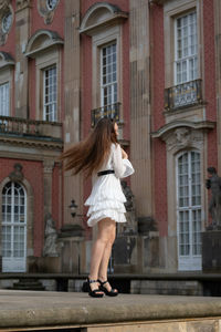Full length of woman walking on street in city