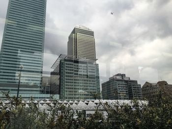 Buildings against cloudy sky