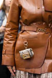 Midsection of woman wearing leather bag