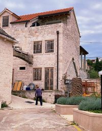 Rear view of man and woman walking outside building