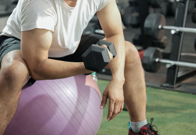 Midsection of man holding mobile phone