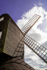 Low angle view of traditional windmill against sky