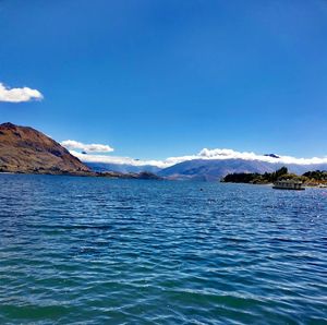 Scenic view of sea against blue sky