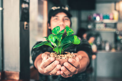 Portrait of man holding leaf