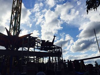 Low angle view of amusement park ride against sky