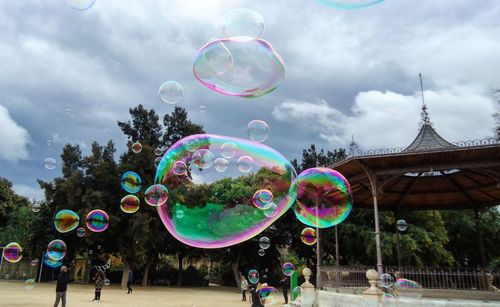 Multi colored bubbles against sky