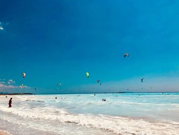 Scenic view of beach against blue sky