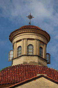 Low angle view of historic cupola and tower against blue sky.