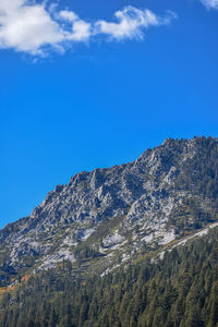 Low angle view of mountain against blue sky