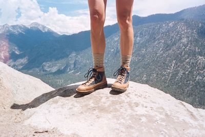 Low section of woman standing on mountain