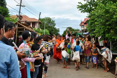 People standing on town square against sky