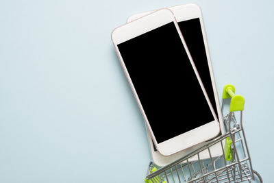 Close-up of mobile phone over white background