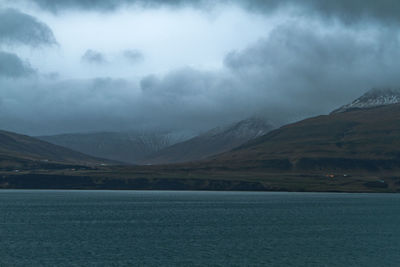 Scenic view of lake and mountains against sky