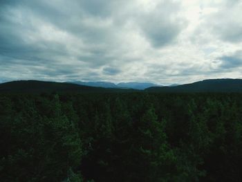 Scenic view of mountains against cloudy sky