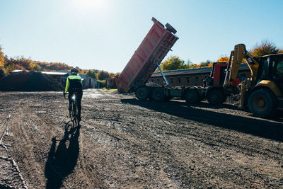 Man working on road against clear sky