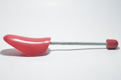 Close-up of red toy over white background