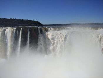 Scenic view of waterfall against clear sky