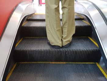 Low section of man on escalator