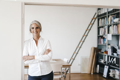 Portrait of a smiling young woman standing on table