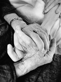 Midsection of senior couple holding hands