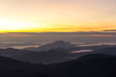 Scenic view of silhouette mountains against sky during sunset