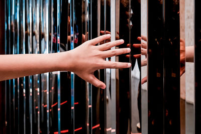 Close up of person hand against a mirrored wall