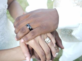 Close-up of couple hands wearing ring during wedding