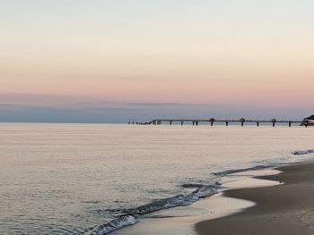 Scenic view of beach against sky during sunset