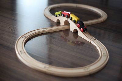 Close-up of train set on wooden table at home