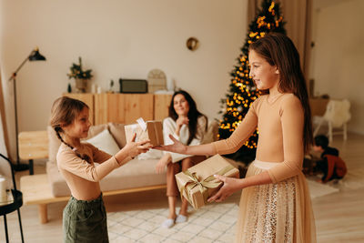 Side view of mother and daughter at home