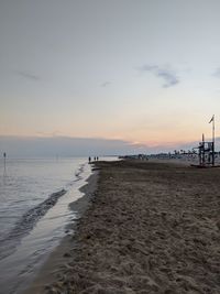 Scenic view of beach against sky during sunset