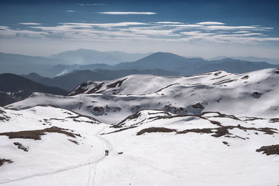 Scenic view of snowcapped mountains against sky