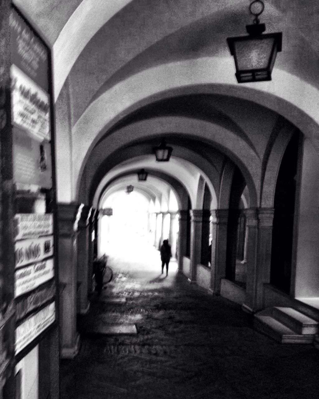 indoors, architecture, arch, built structure, walking, full length, men, rear view, lifestyles, the way forward, corridor, illuminated, lighting equipment, silhouette, person, tunnel, building, leisure activity