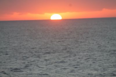 Scenic view of sea against romantic sky at sunset